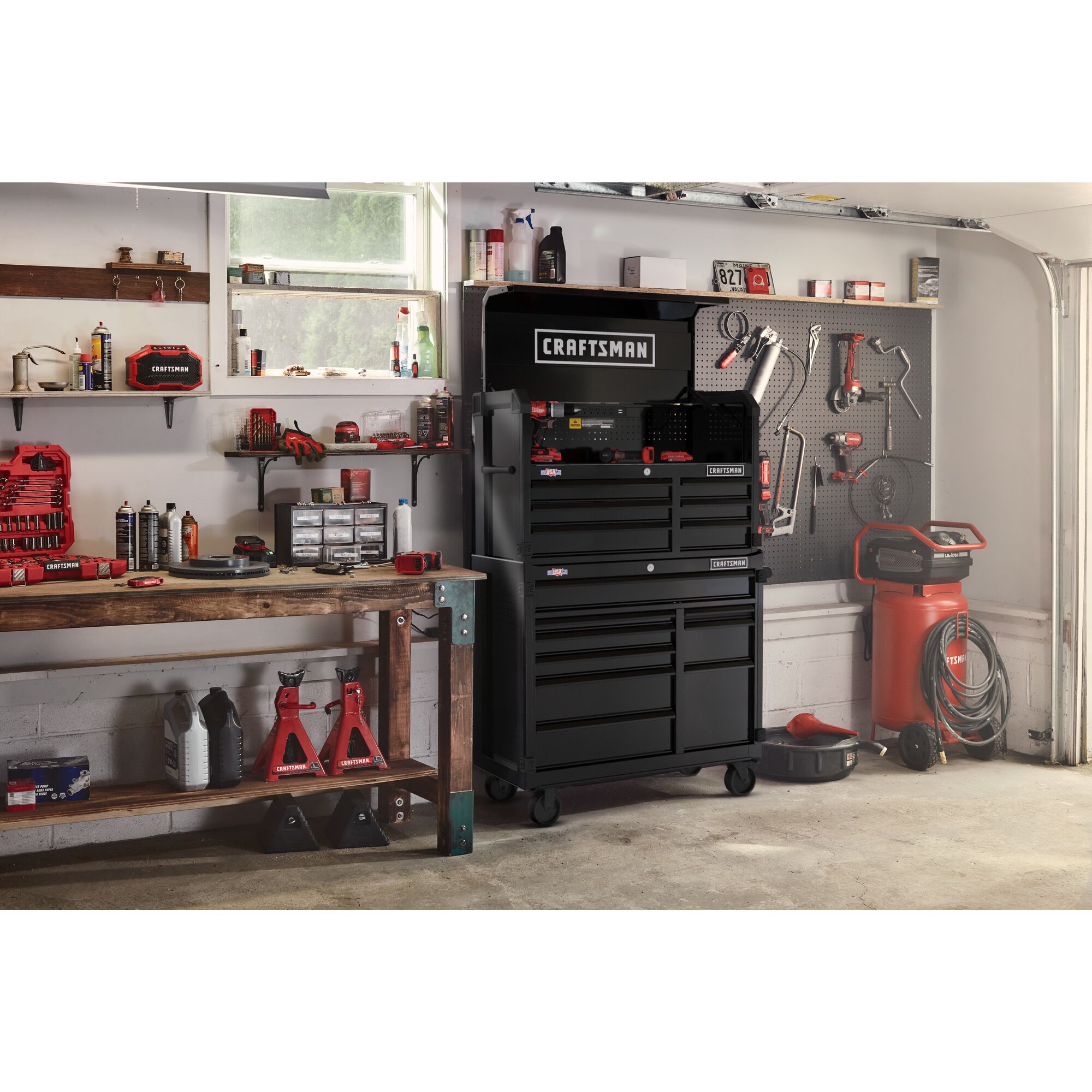 Black CRAFTSMAN Premium S2000 Series 41-inch wide Metal Tool Storage Cabinet and chest stacked on top of each other in a residential garage setting, surrounded by other CRAFTSMAN tools.