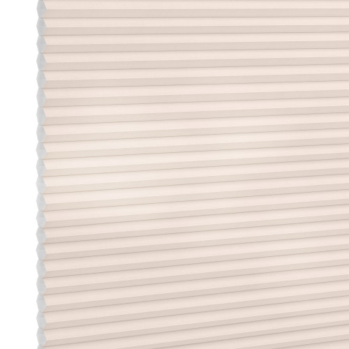 Cellular (honeycomb) pleated blind, cream-colored, fully lowered and closed with visible hexagonal cells; diffusing soft light across a plain interior wall, suggesting a bright, neutral room.