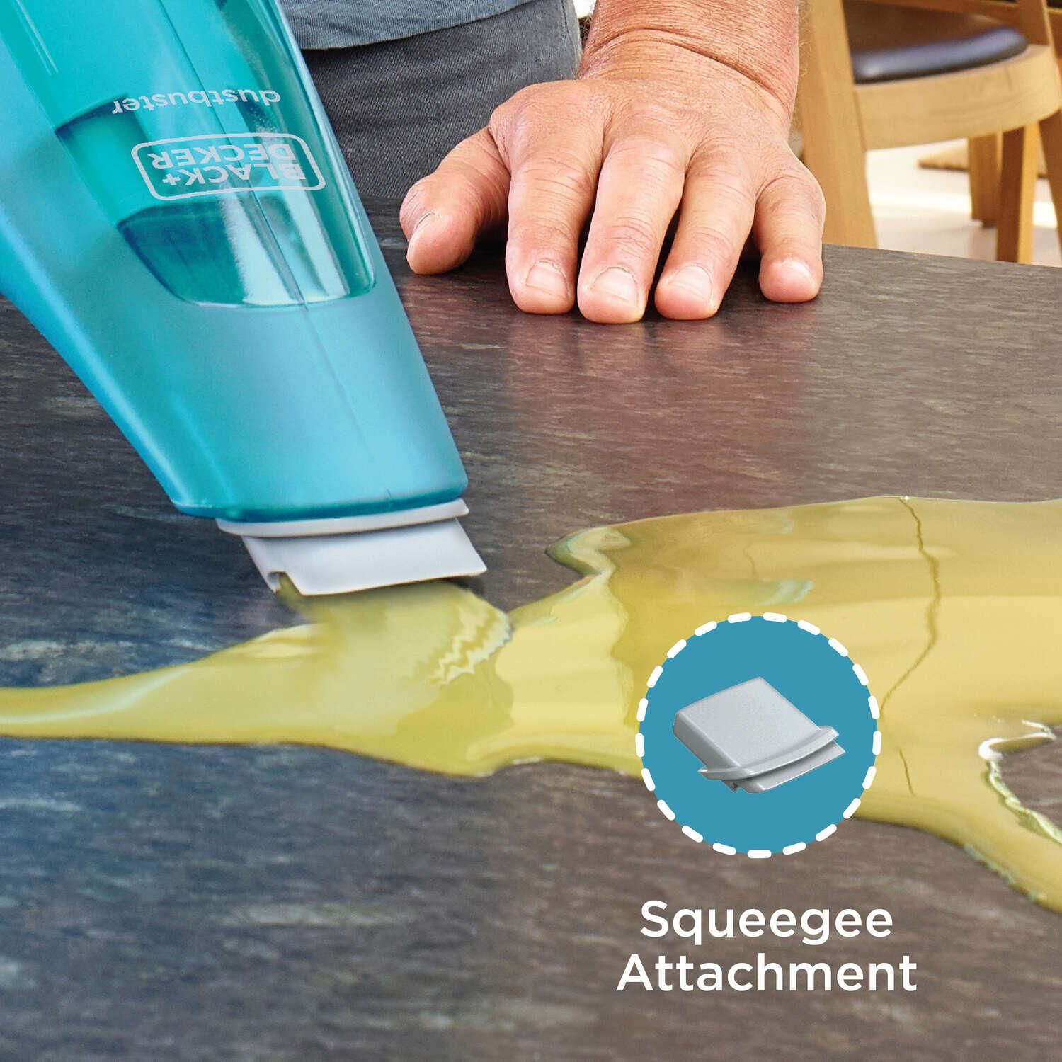 Dustbuster QuickClean Cordless Hand Vacuum Wet or Dry being used by person to clean spilled juice from countertop.