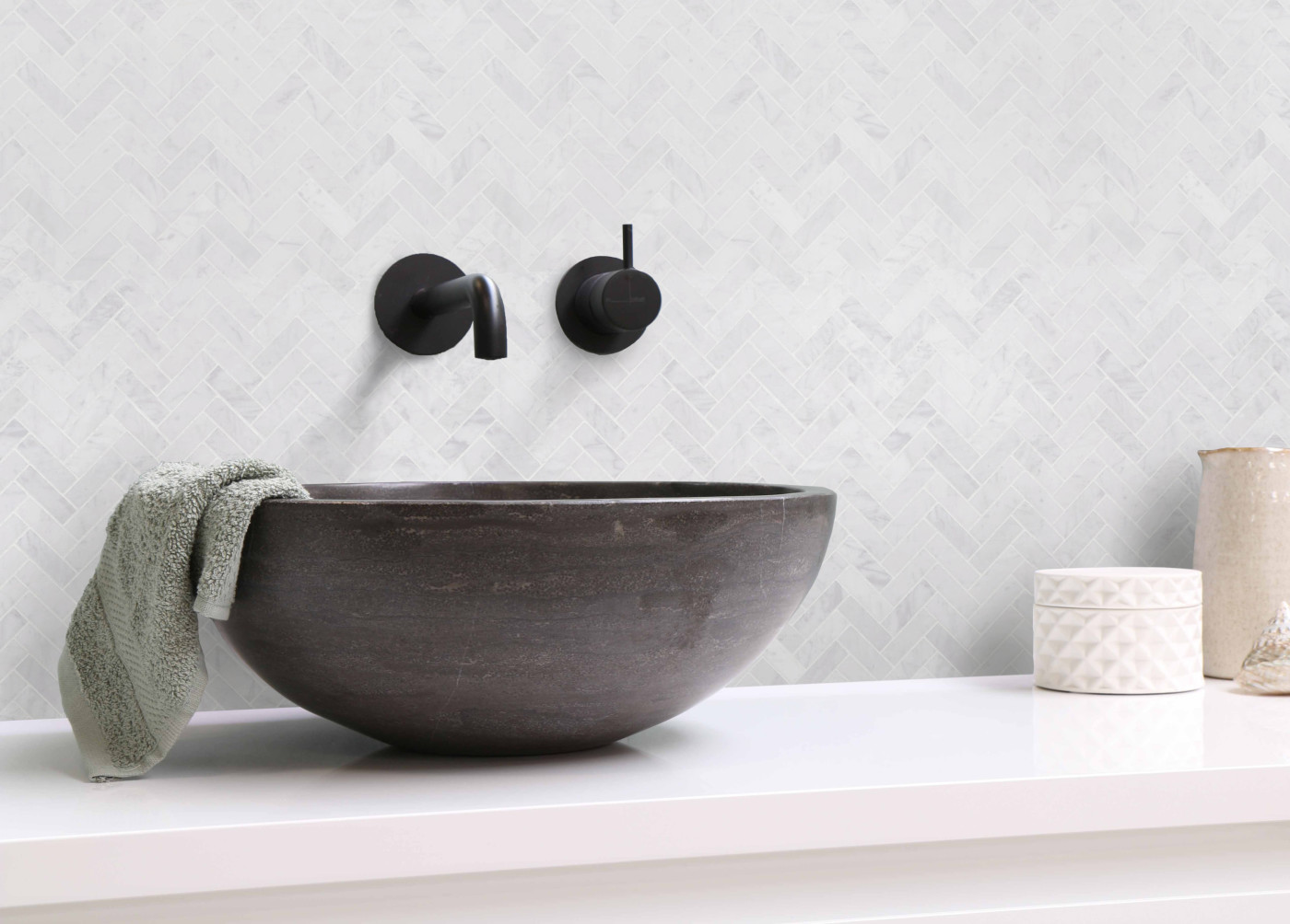 a black bowl sink on a white counter.