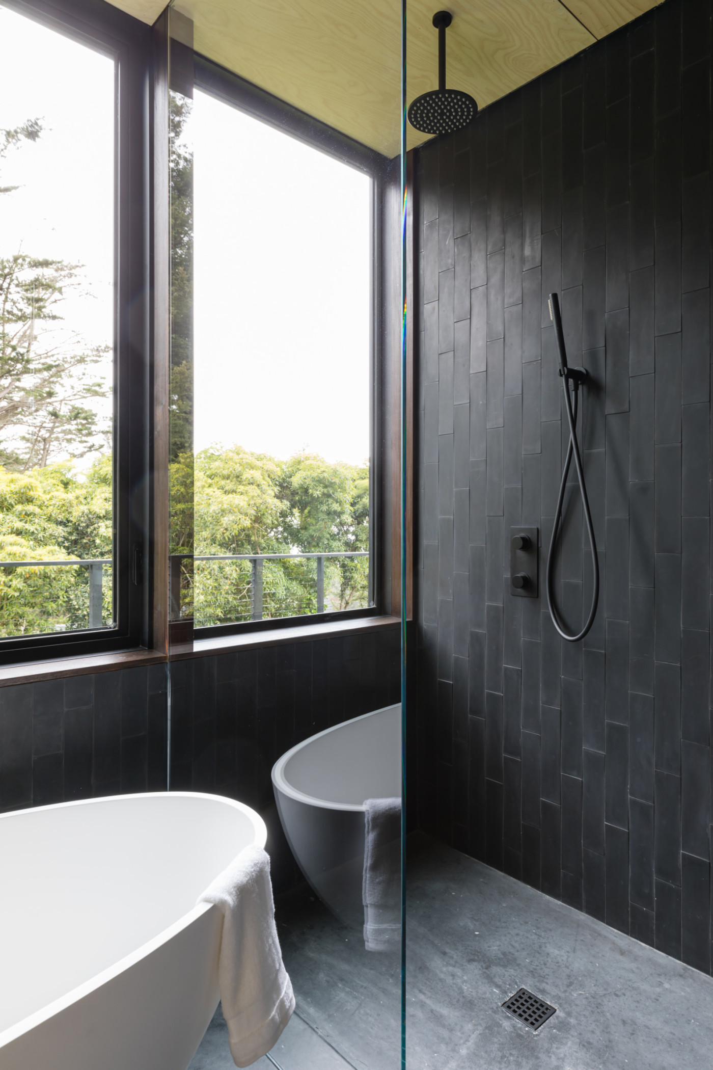 a bathroom with a bathtub and a window.