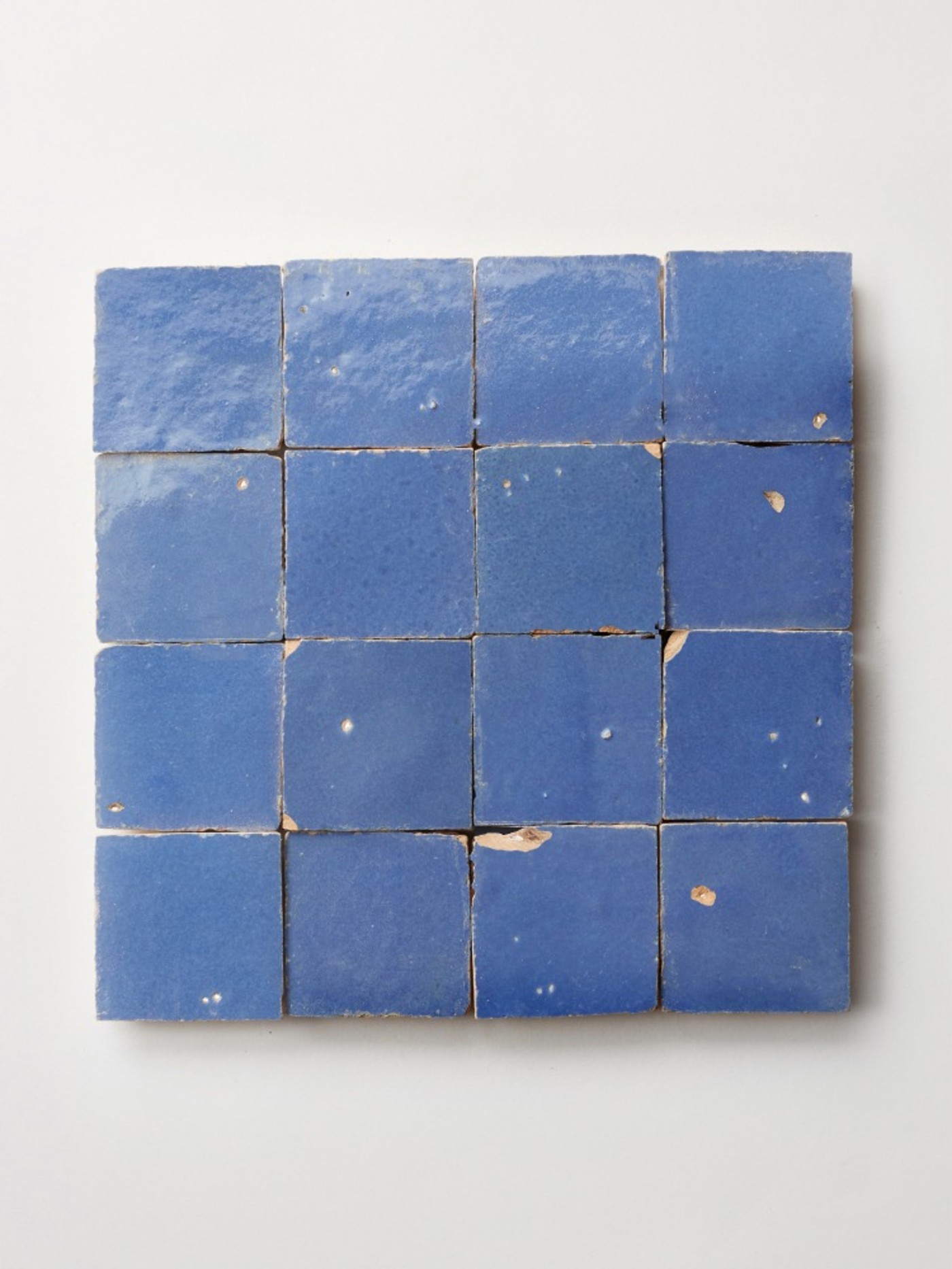 square blue tiles on a white surface.