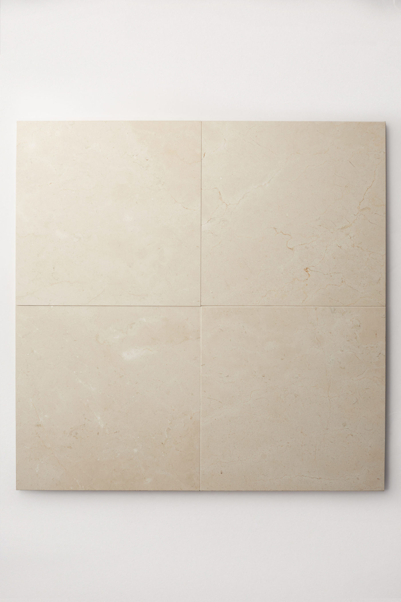 four cream colored square limestone tiles laid together making one large square