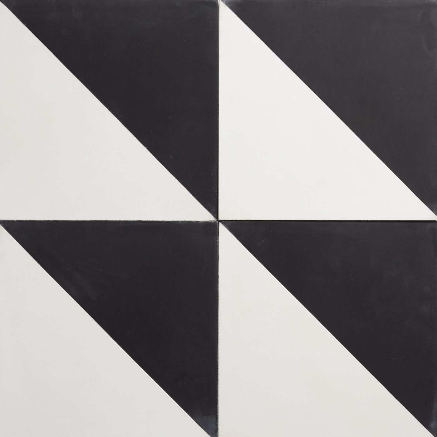 four black and white tiles with triangles on them.