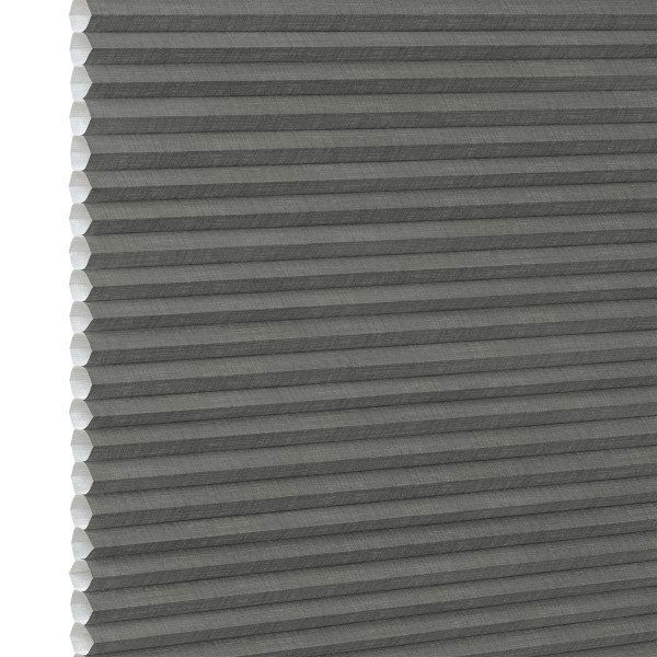 Gray cellular (honeycomb) pleated blind, fully lowered and closed, blocking light; close-up interior view showing textured fabric and white left-side gap under neutral lighting.