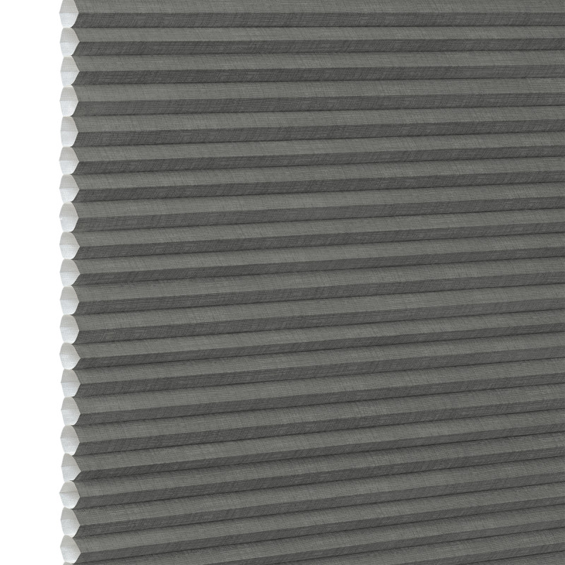 Gray cellular (honeycomb) pleated blind, fully lowered and closed, blocking light; close-up interior view showing textured fabric and white left-side gap under neutral lighting.