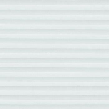 White cellular (honeycomb) pleated blinds, lowered and closed, filtering soft daylight through evenly spaced horizontal folds, covering a window in a neutral, softly lit interior.