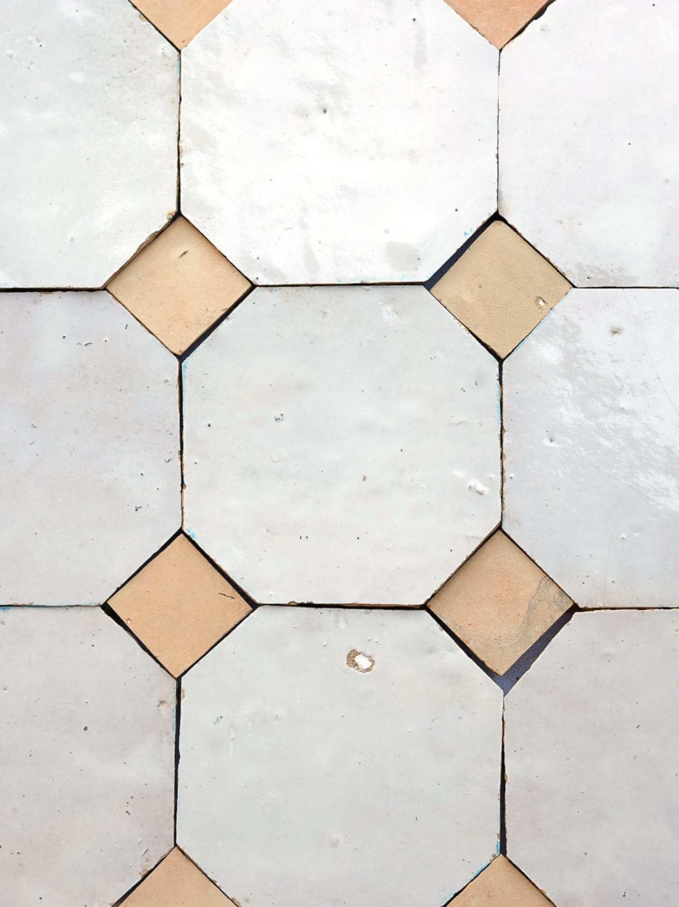 white and tan tiles arranged in a pattern.