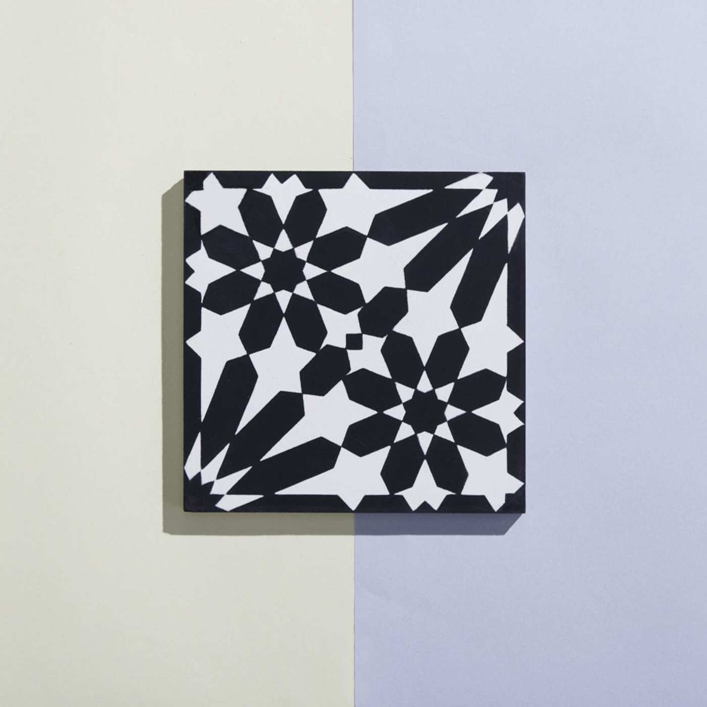 a black and white tile on a blue and white background.