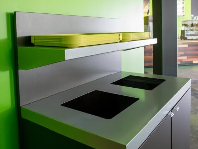 waste and recycling bin with metal lid and shelf for collecting food trays in a modern quick service restaurant