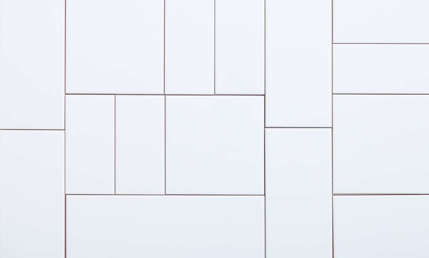 a close up of a white tile surface.