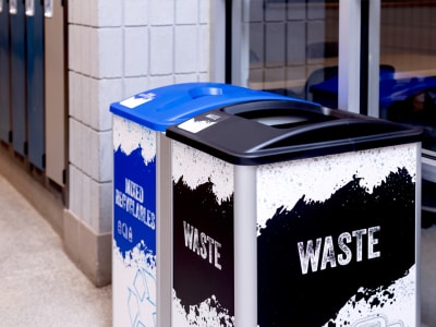 mixed recycling and waste containers with bold modern design signs and labels