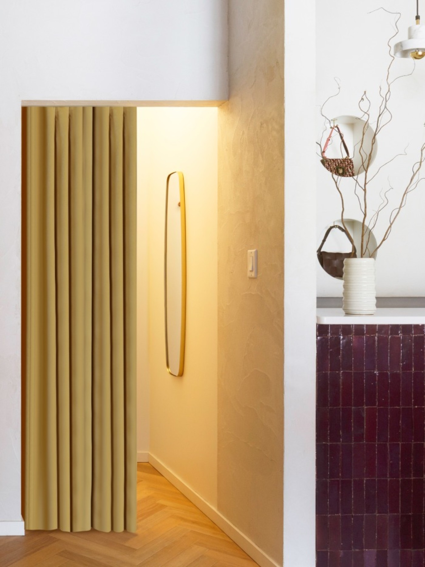 a doorway with a yellow curtain and a wooden floor.