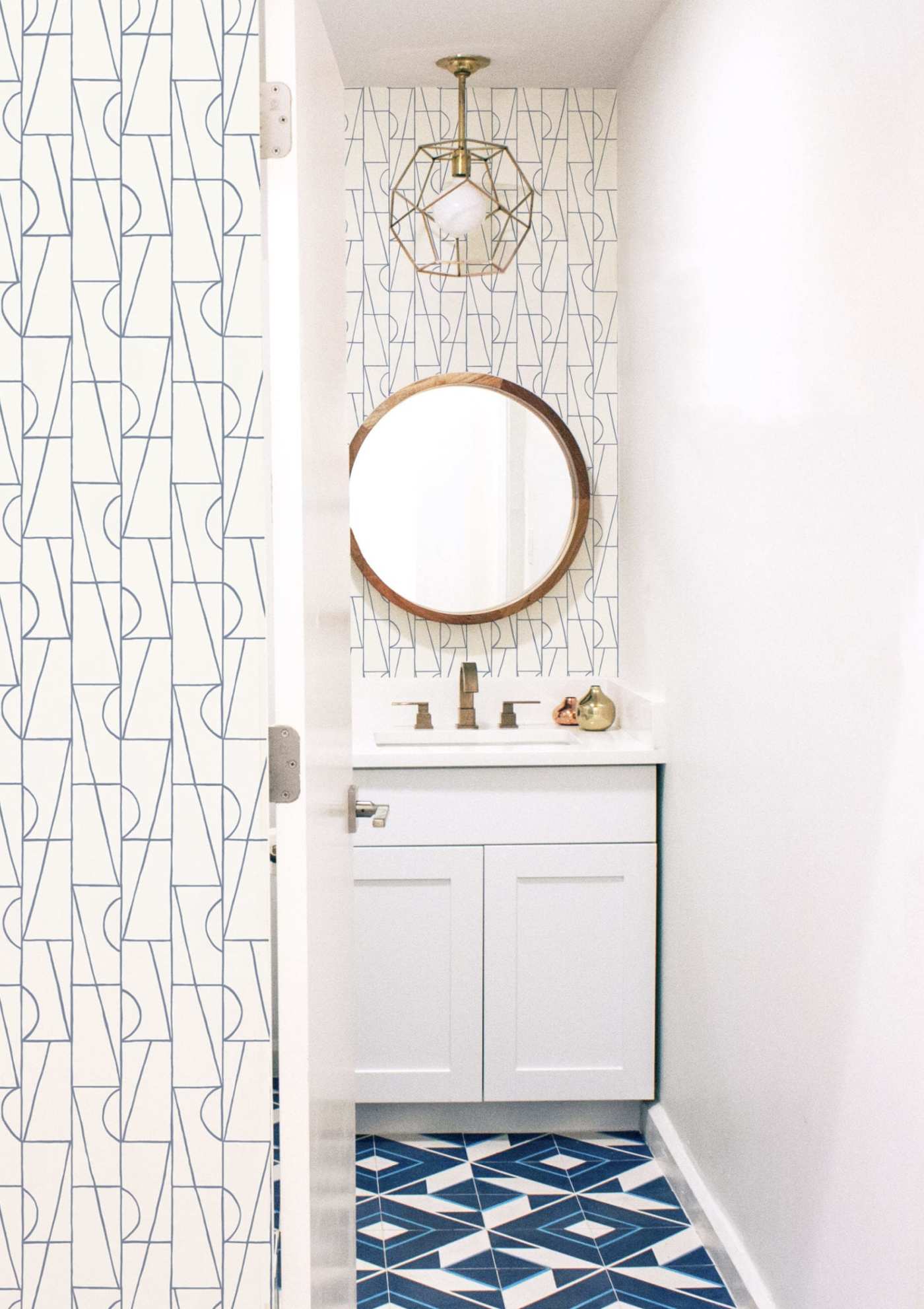 a bathroom with a blue and white tiled floor.