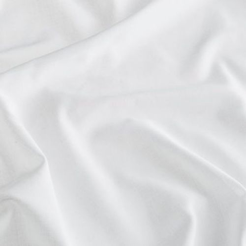 White satin fabric spread across a surface, rumpled into gentle folds and creases that catch soft diffuse light, close-up view with a neutral background.