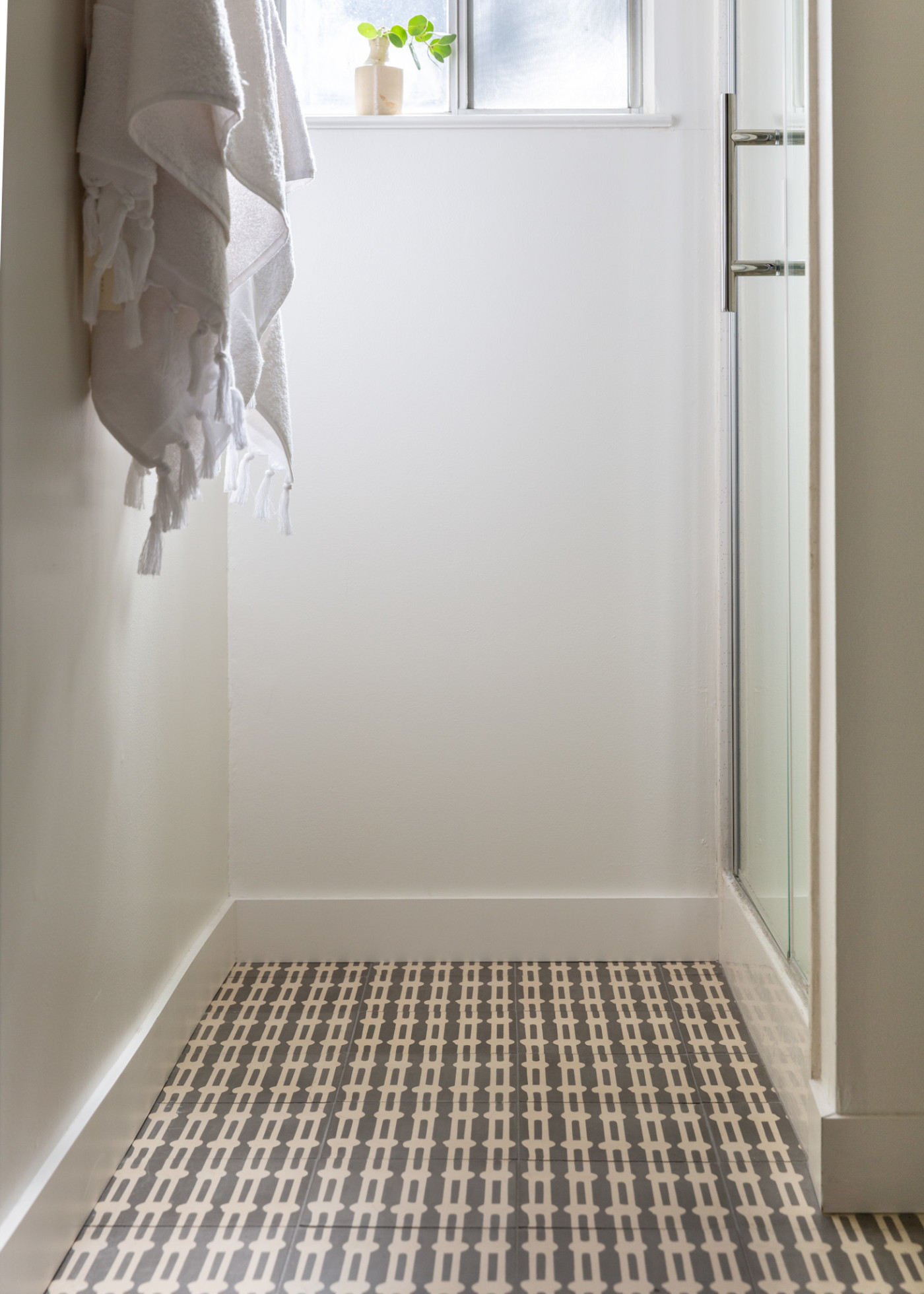 a black and white tiled floor in a bathroom.