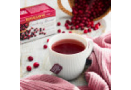 Lifestyle image of a cup of Cranberry Harvest Herbal Tea
