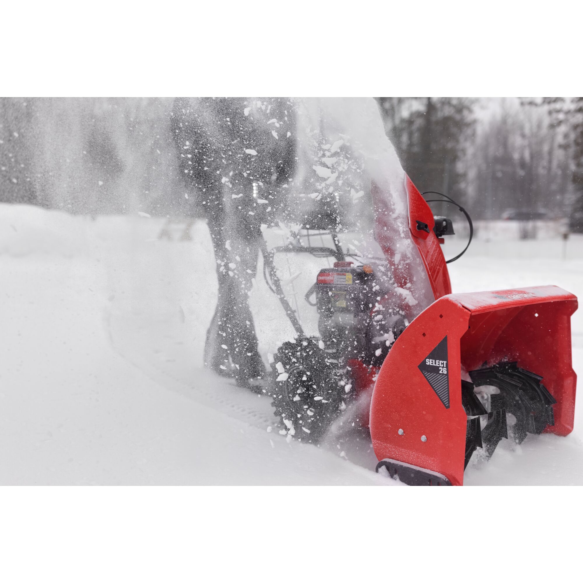 CRAFTSMAN Select 26 Snowblower zoomed in clearing snow from driveway trees in background