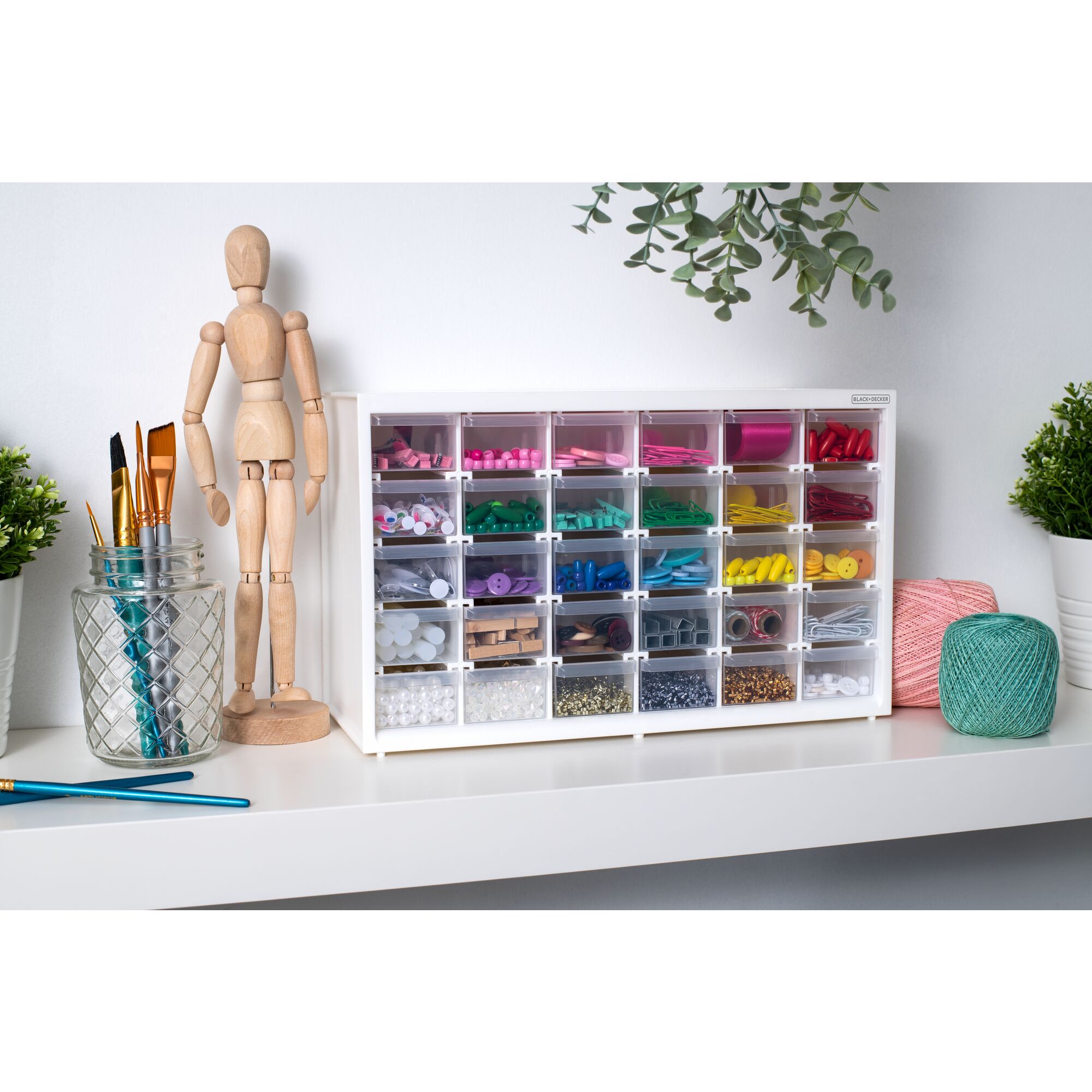 BLACK+DECKER 30 drawer material bin filled with various colorful crafting materials sitting on a shelf