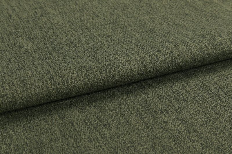 Olive-green textured upholstery fabric, folded once creating an overlapping edge; tightly woven, slightly napped surface; photographed in a close-up, evenly lit studio setting emphasizing texture.