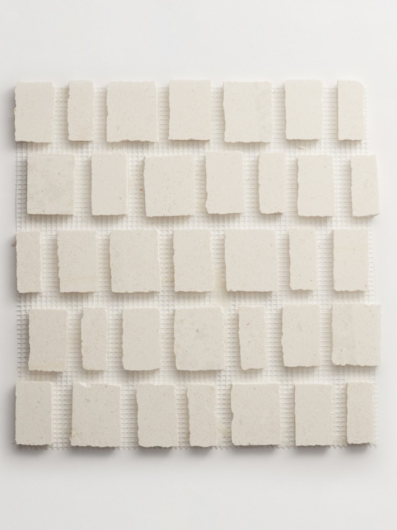 a white tile with white squares on a white surface.