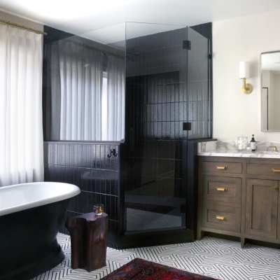 a bathroom with black walls and a black tub.