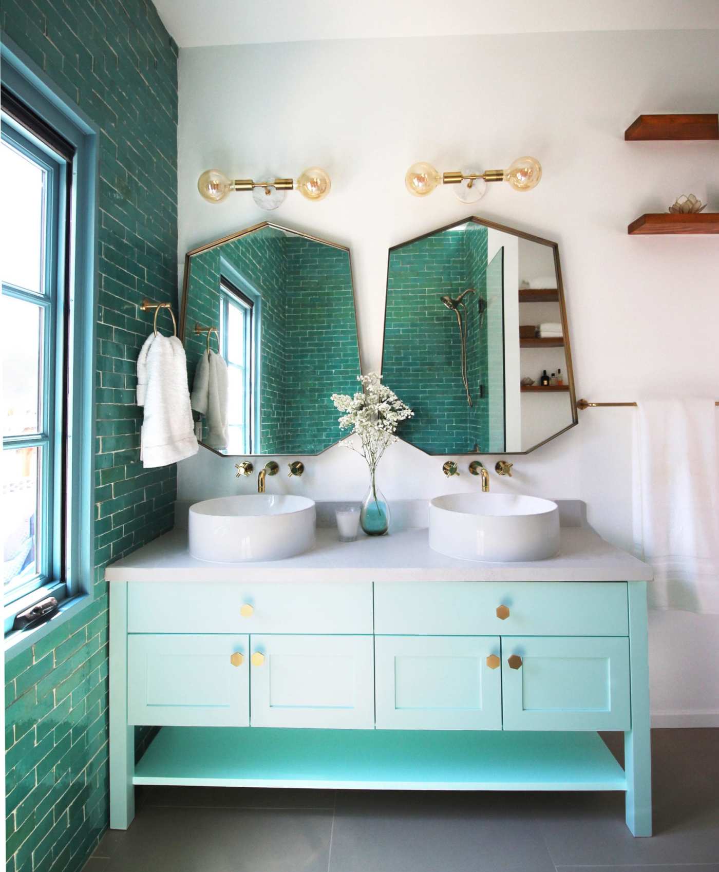 a bathroom with two sinks and two mirrors.