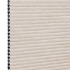 Beige cellular (honeycomb) window shade, pleated and fully lowered with exposed black cell openings along the left edge, blocking light and showing a textured fabric surface against a white background.