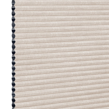 Beige cellular (honeycomb) window shade, pleated and fully lowered with exposed black cell openings along the left edge, blocking light and showing a textured fabric surface against a white background.