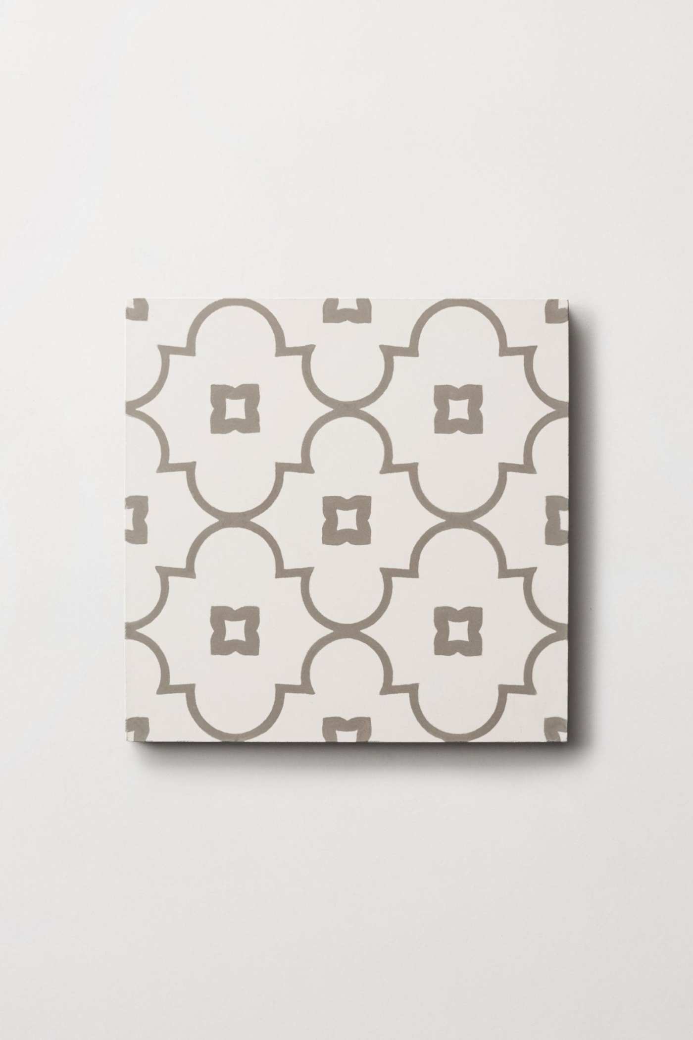 a white and gray tile with a geometric pattern.