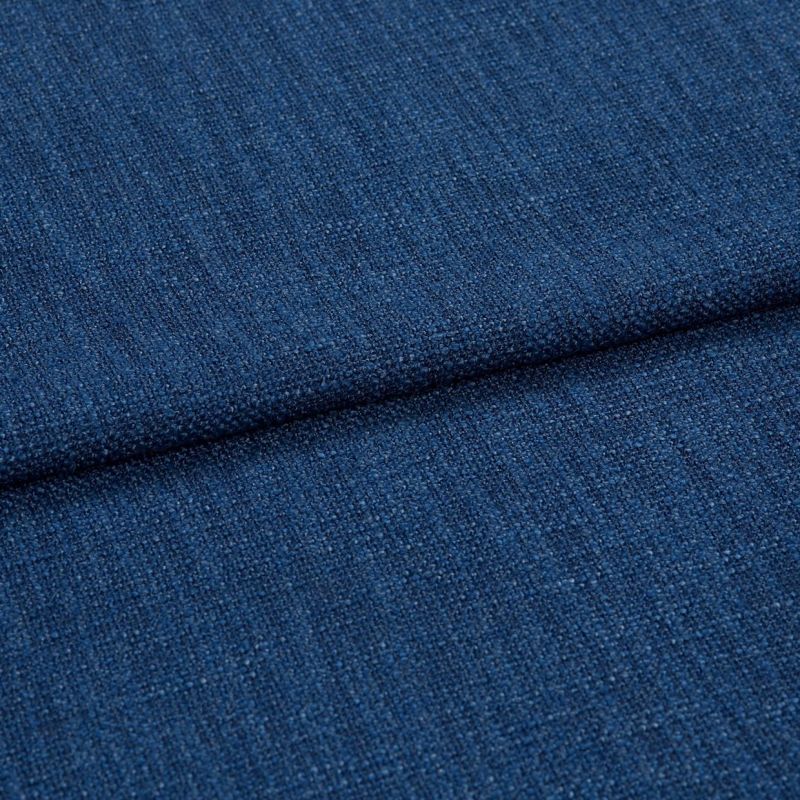 Blue textured upholstery fabric (tight weave) folded across the frame, showing a horizontal crease; close-up studio-lit view emphasizing coarse threads and uniform deep-blue color.