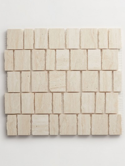 a tile made of beige tiles on a white surface.