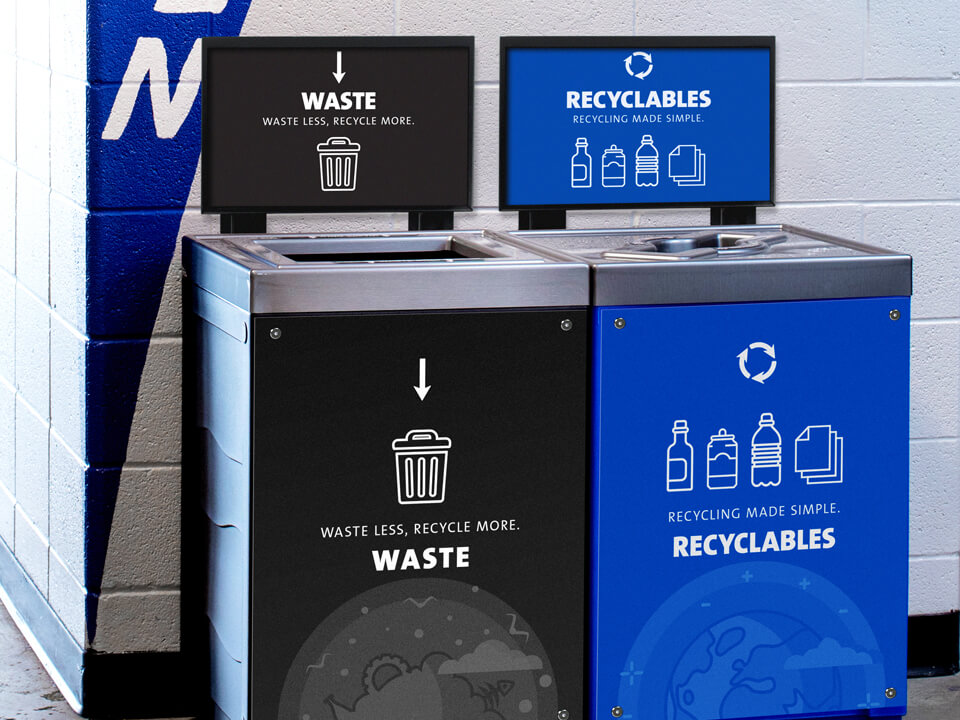 double waste and recyclables collection station with large body signs and sign frames in a sports stadium