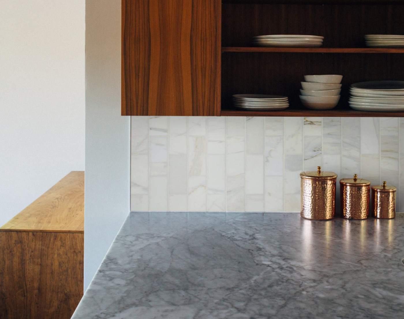 a kitchen with wooden cabinets and a stone counter top.