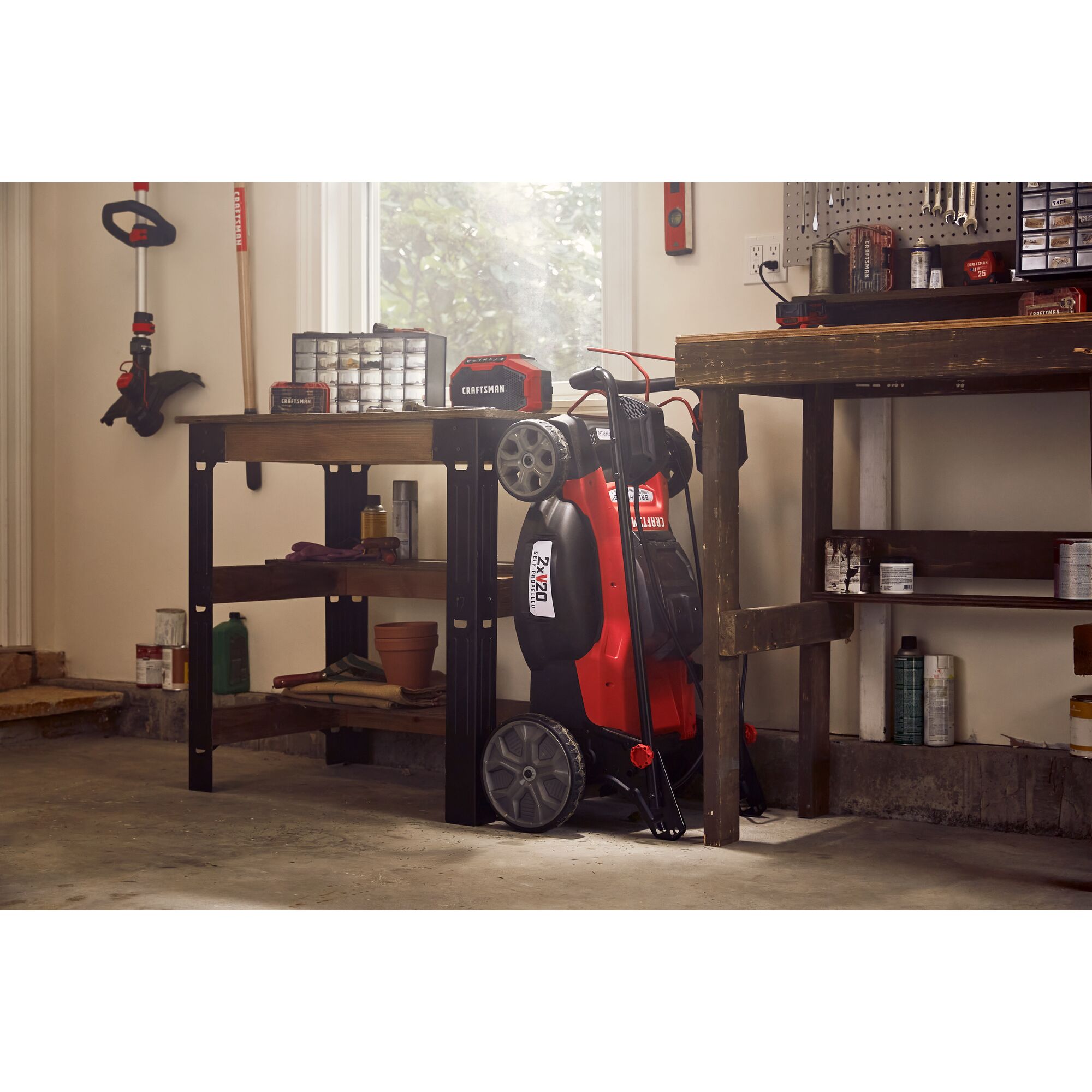 20 inch brushless cordless self propelled mower kit placed in storage room.
