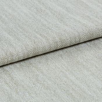 A beige, tightly woven upholstery fabric folded once, revealing a textured basket-weave edge; lying flat on a neutral surface under soft, even studio lighting.