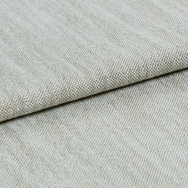 A beige, tightly woven upholstery fabric folded once, revealing a textured basket-weave edge; lying flat on a neutral surface under soft, even studio lighting.