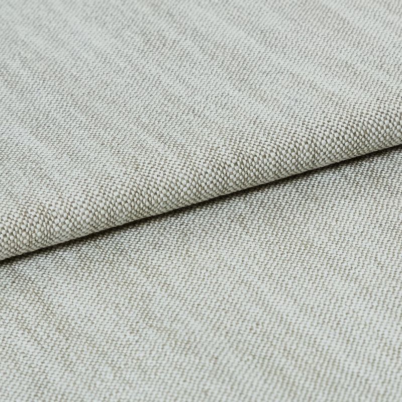 A beige, tightly woven upholstery fabric folded once, revealing a textured basket-weave edge; lying flat on a neutral surface under soft, even studio lighting.