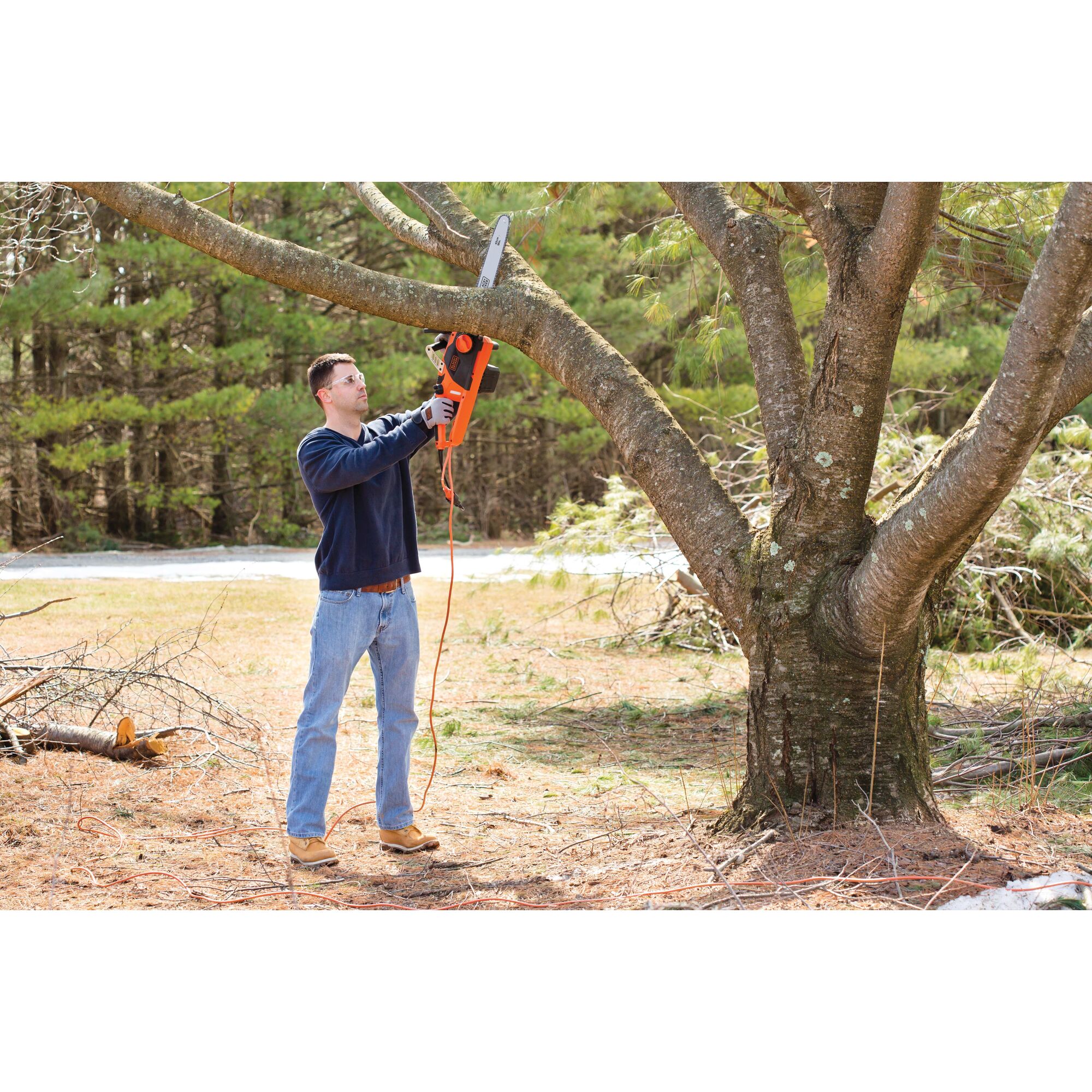 Chainsaw being used by a person to cut tree.\n