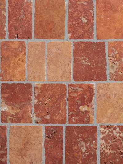 a close up image of a red and brown tiled floor.
