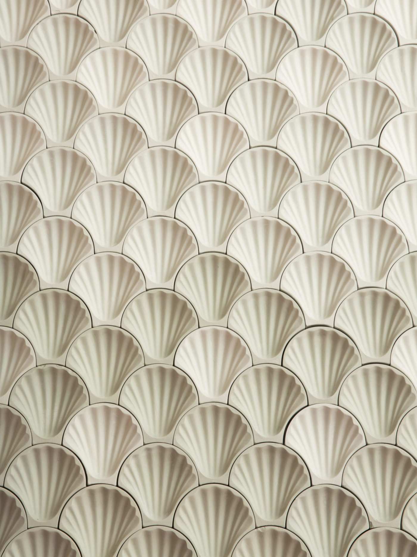 a surface of white shell-shaped tiles.