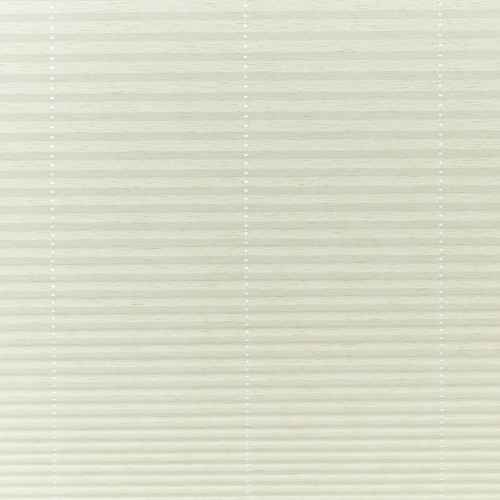 Cream cellular pleated blinds covering the window, closed and gently filtering soft daylight; three faint vertical cord lines with small white grommets, neutral interior lighting.