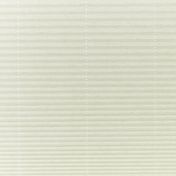 Cream cellular pleated blinds covering the window, closed and gently filtering soft daylight; three faint vertical cord lines with small white grommets, neutral interior lighting.