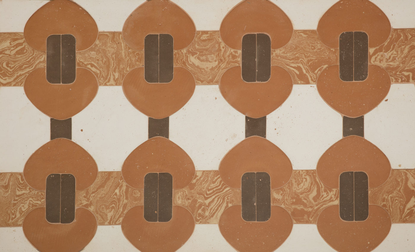 a tiled surface with brown, red, and white designs on it.