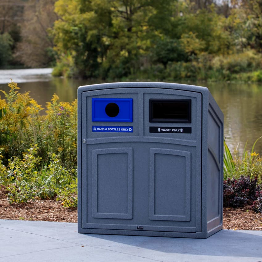 double opening waste and recycling station made from durable LDPE plastic with labels sitting on a walking path in a city park