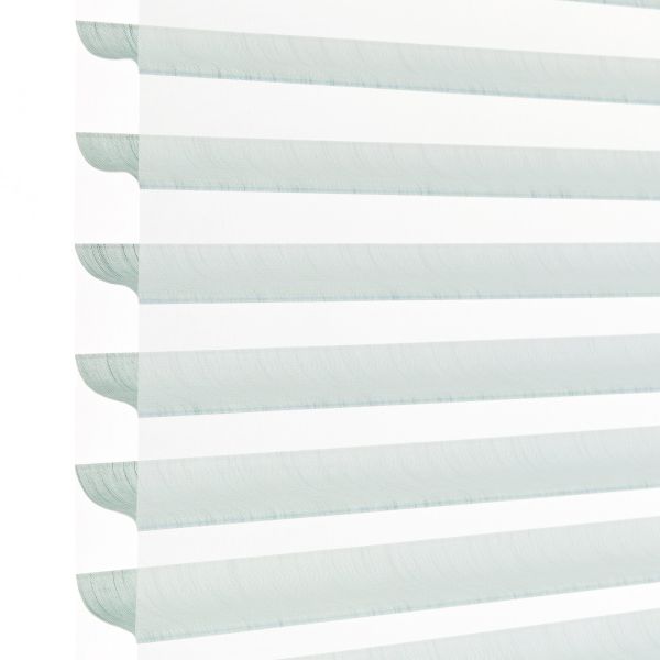 Layered horizontal zebra blind with alternating pale aqua translucent and opaque white fabric stripes, hanging lowered; filtering daylight and softly diffusing light in a bright, minimal indoor setting.