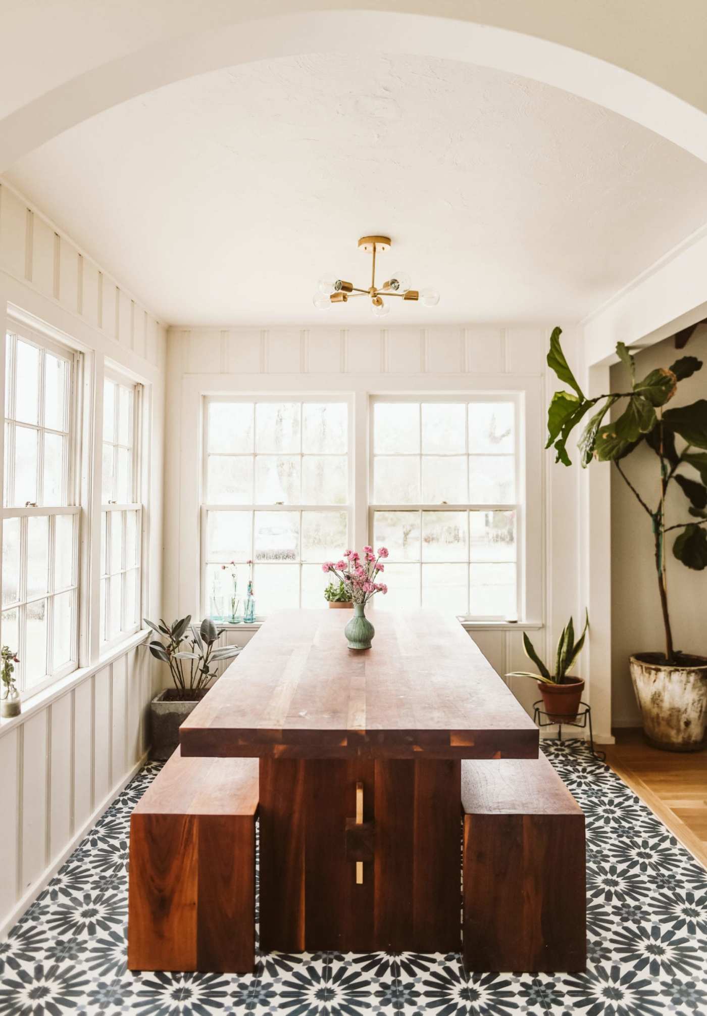 a dining room with a black and white tile floor.