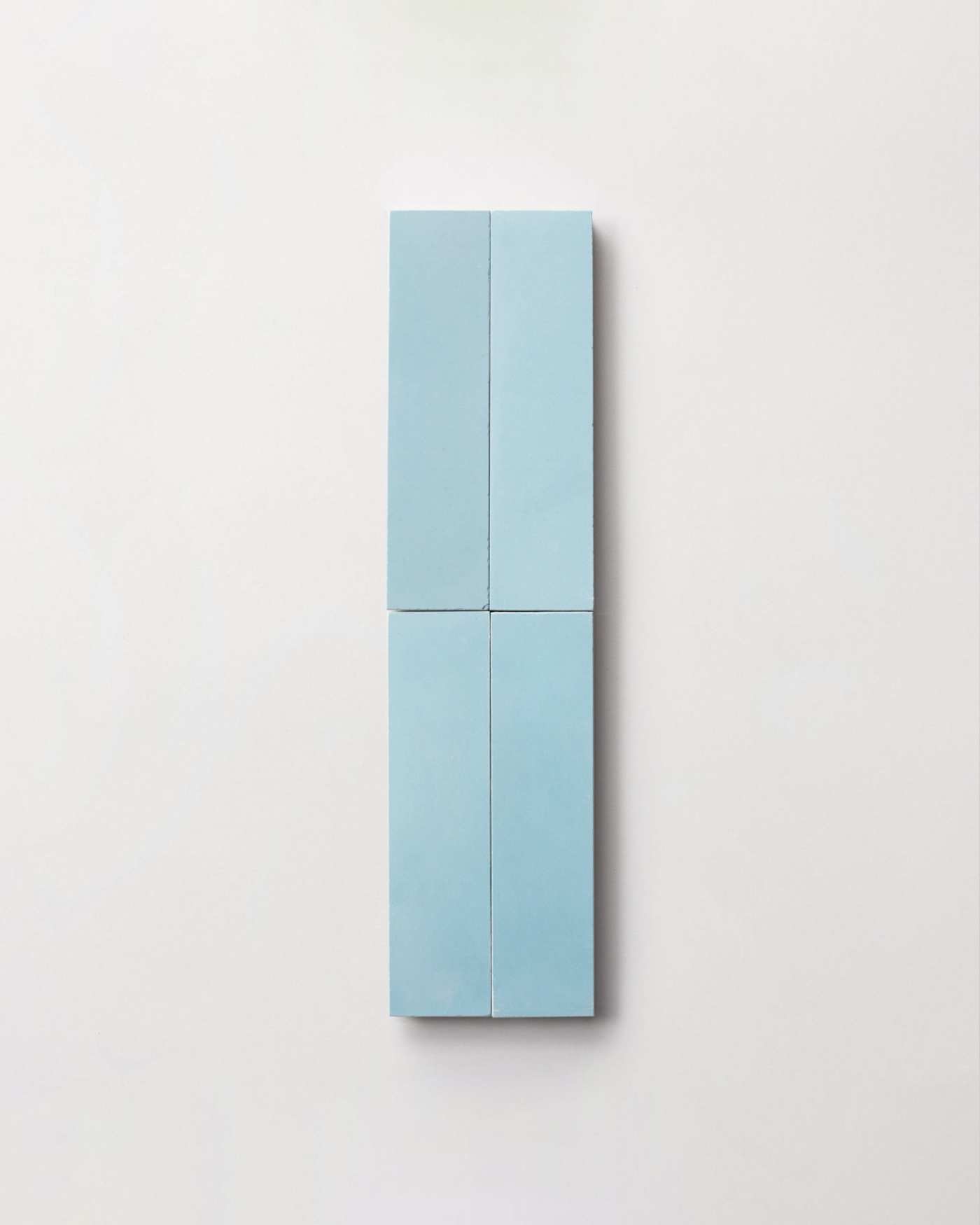 four light blue rectangle tiles on a white surface.