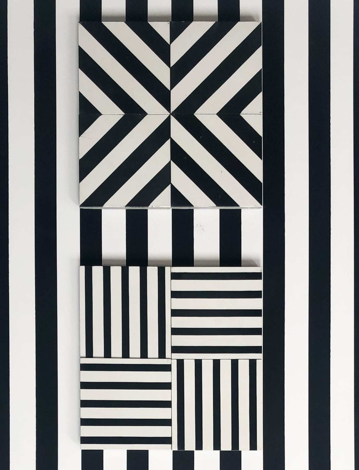 black and white striped tiles on a wall.