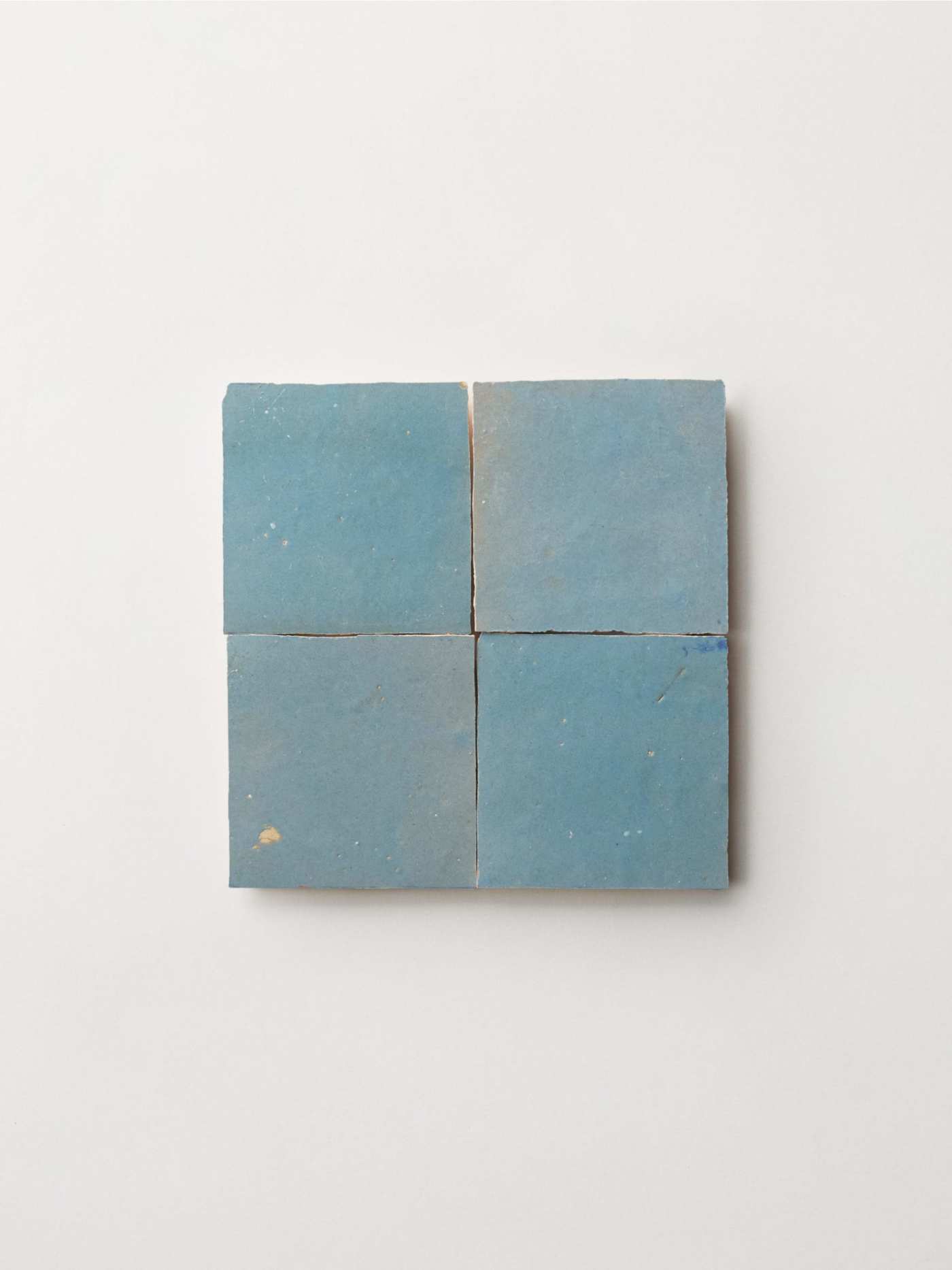 a set of blue tiles on a white surface.